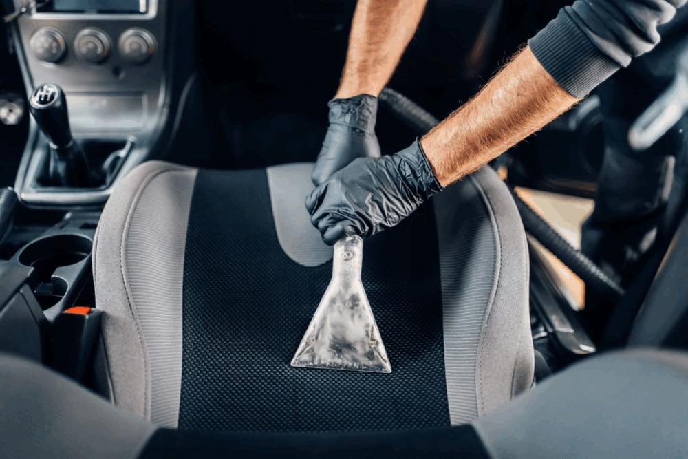 Steam cleaning a used car seat during a Used Car Fresh Start Valet in West London