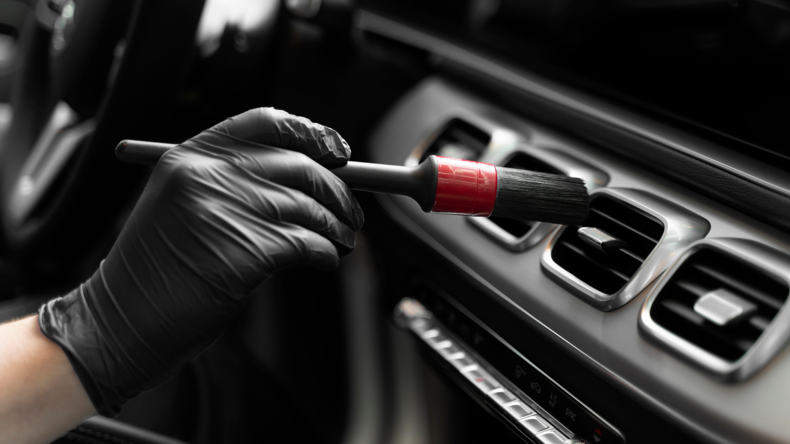 Cleaning car air vents with brush