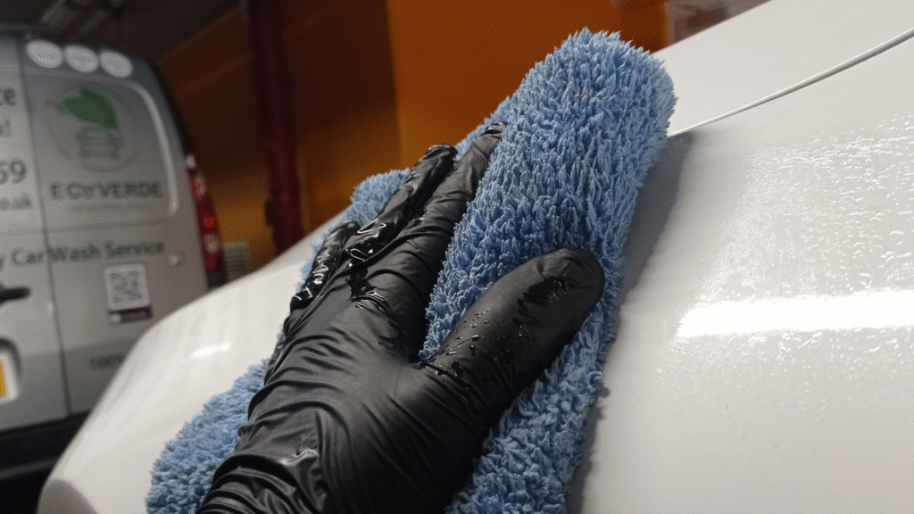 Hand drying a car with cloth