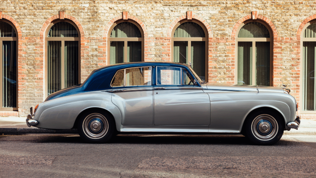 Classic silver car parked by building