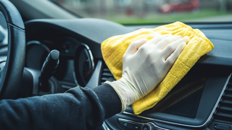 Cleaning car dashboard with yellow cloth