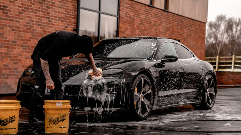 Person washing a black sports car