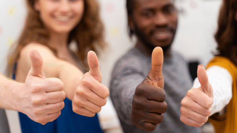 Four people giving thumbs up.